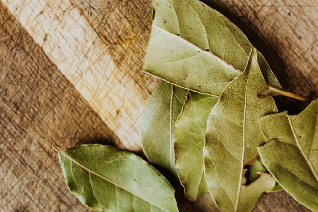 Dried bay leaves on a wooden board for bay leaf spells.