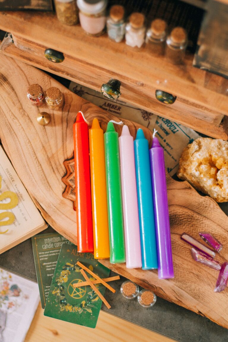 Rainbow colored candles for candle color meanings in spellwork.