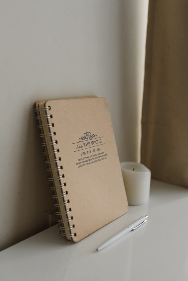 Notebook, pen, and candle for writing a spell.