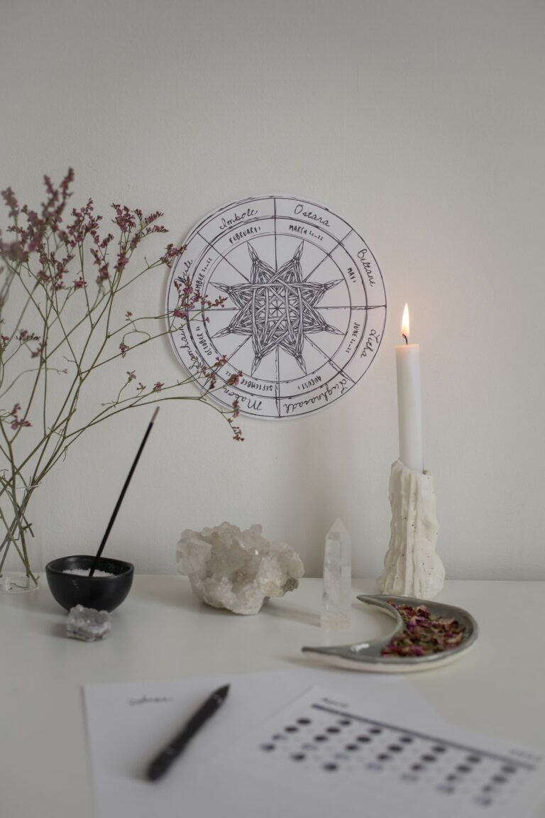 A small witchcraft practice setup with candles, cards, and ritual objects.