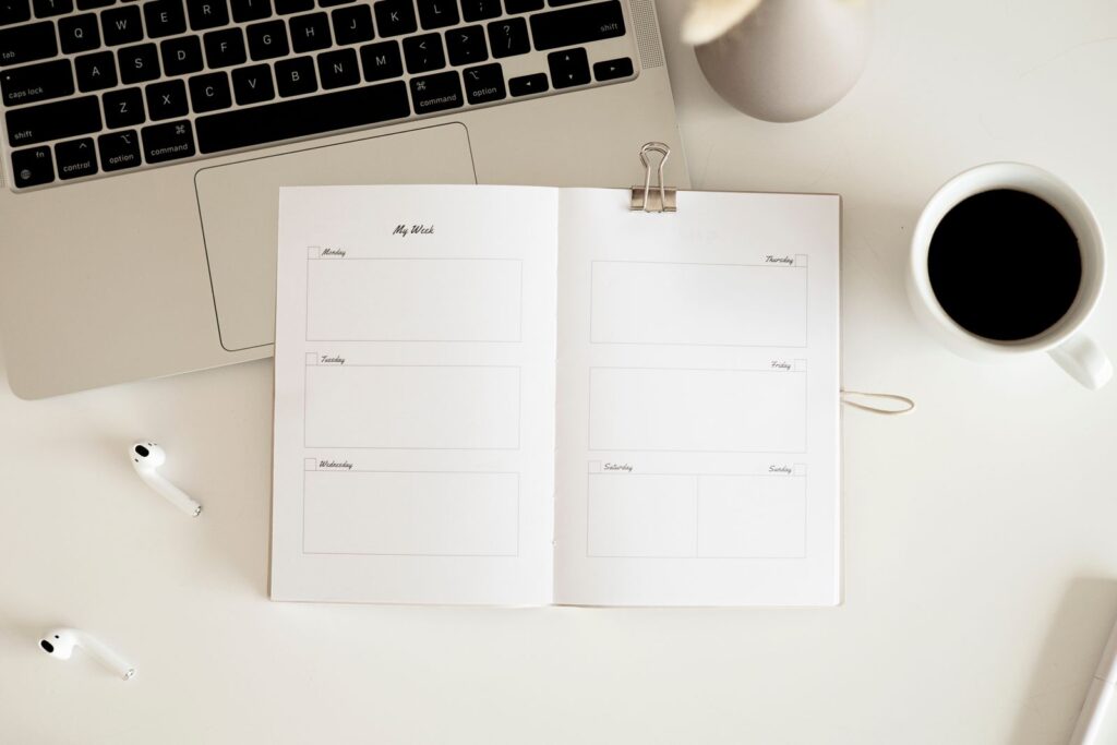 Open planner notebook on a desk for witchcraft planner ideas.