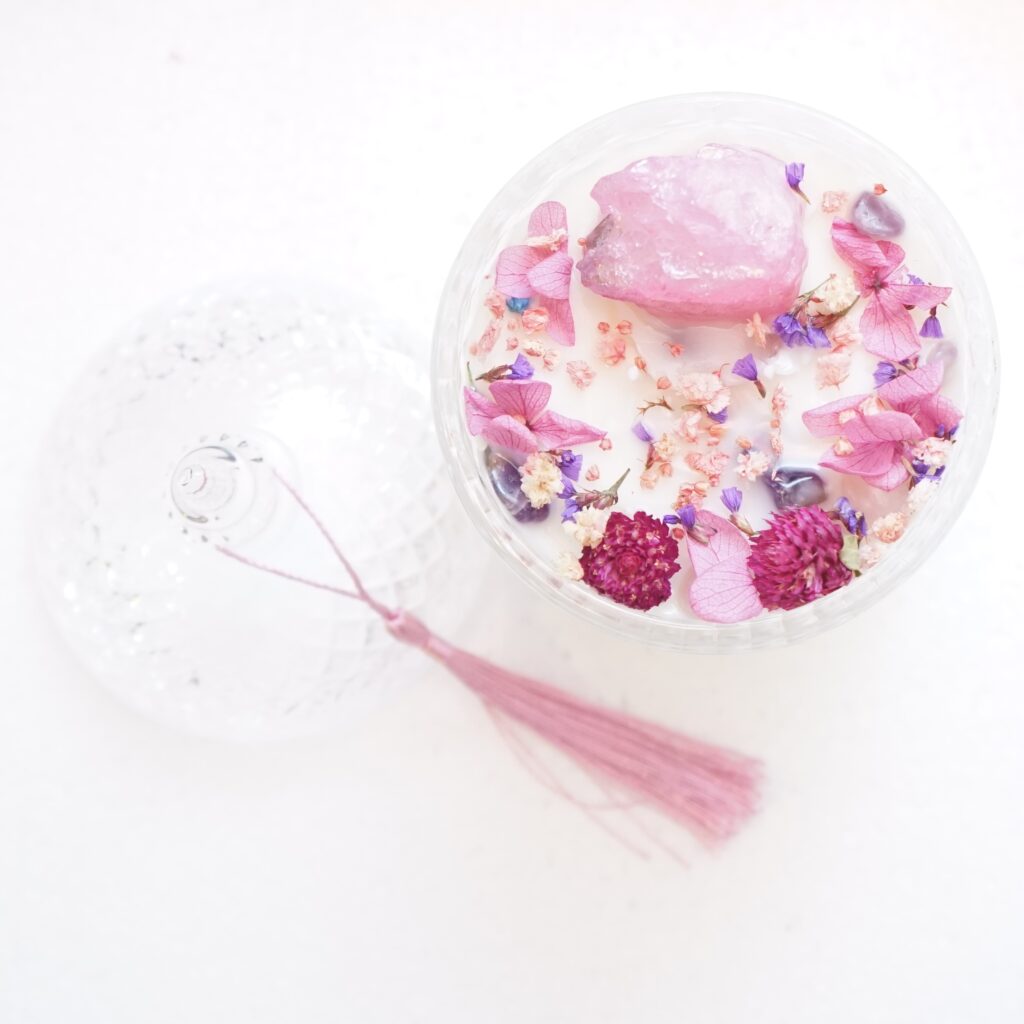 A crystal and floral candle arrangement for gentle crystal charging.